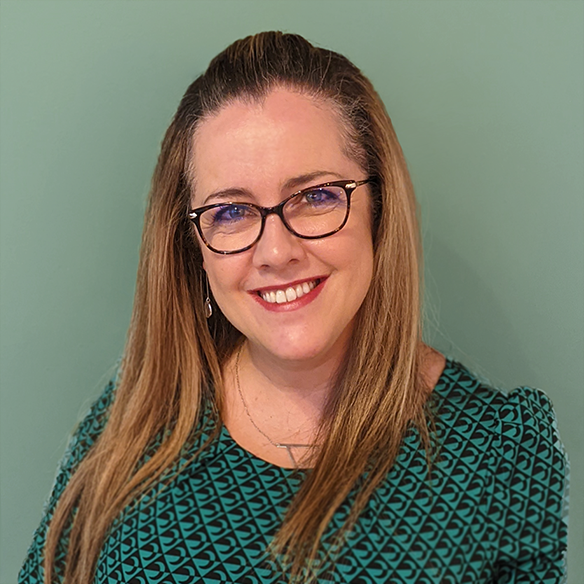 A close up photo of Angela Watson, found of Life Squared Coaching, against a green background